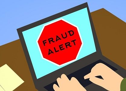 laptop screen with image that says Fraud Alert